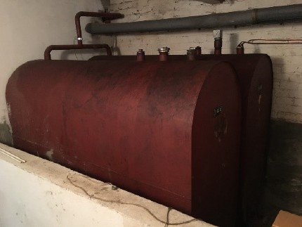 inefficient old heating oil boiler and the heating oil storage tank 